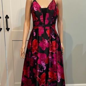 Long formal flowered gown worn to a wedding.
